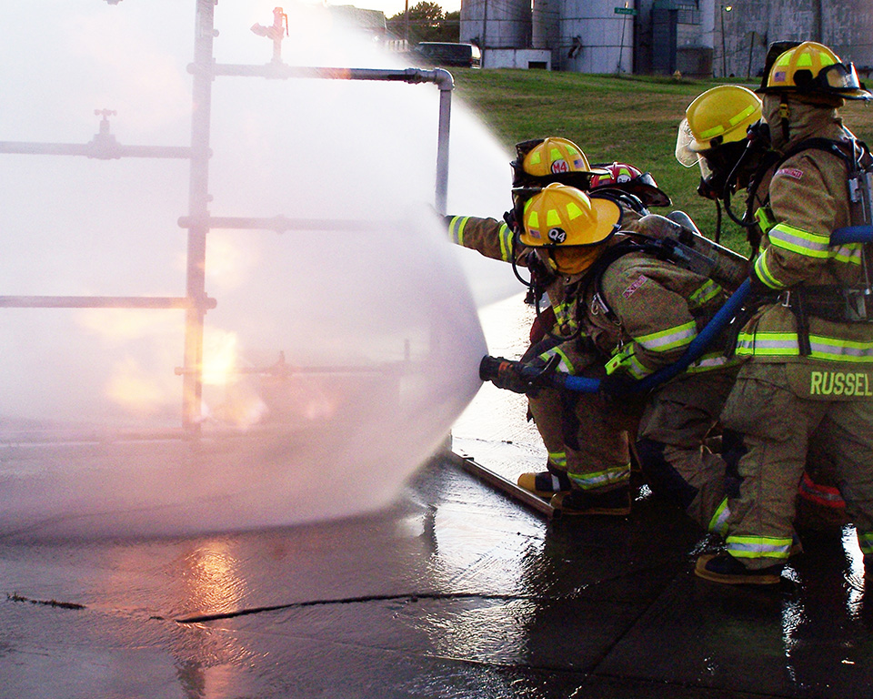 Firefighters spraying water during training