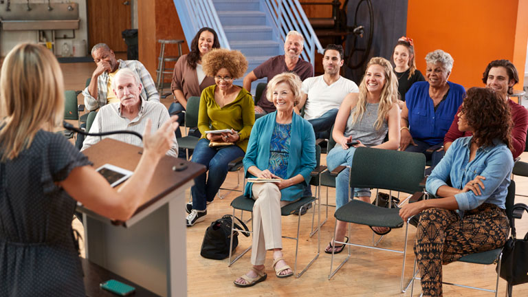 attendees listening to a speaker
