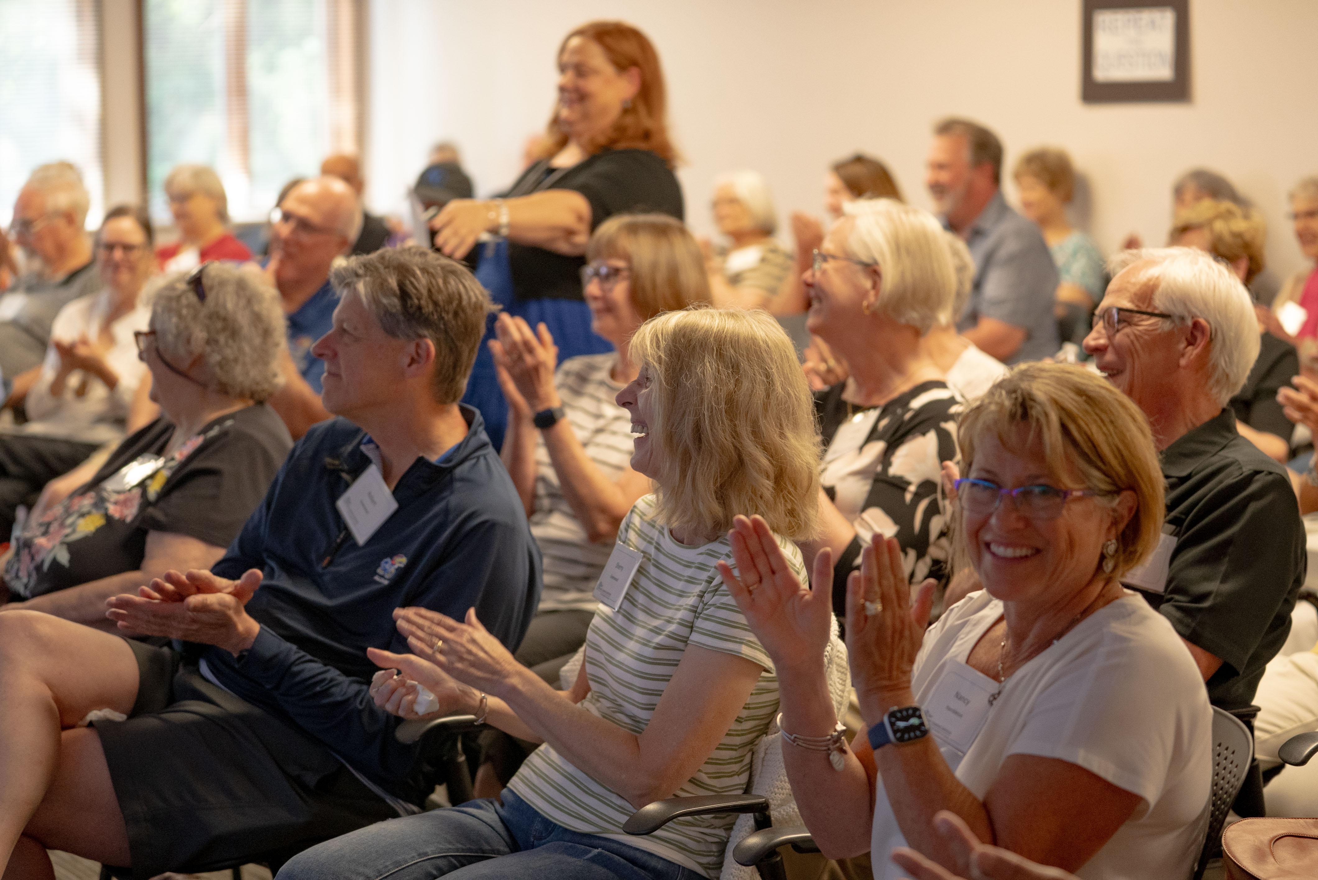 An audience applauds during a KU Osher event in 2025.