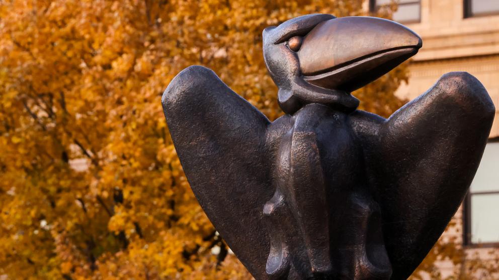 Stone Jayhawk Statue in front of Strong Hall on the Lawrence campus